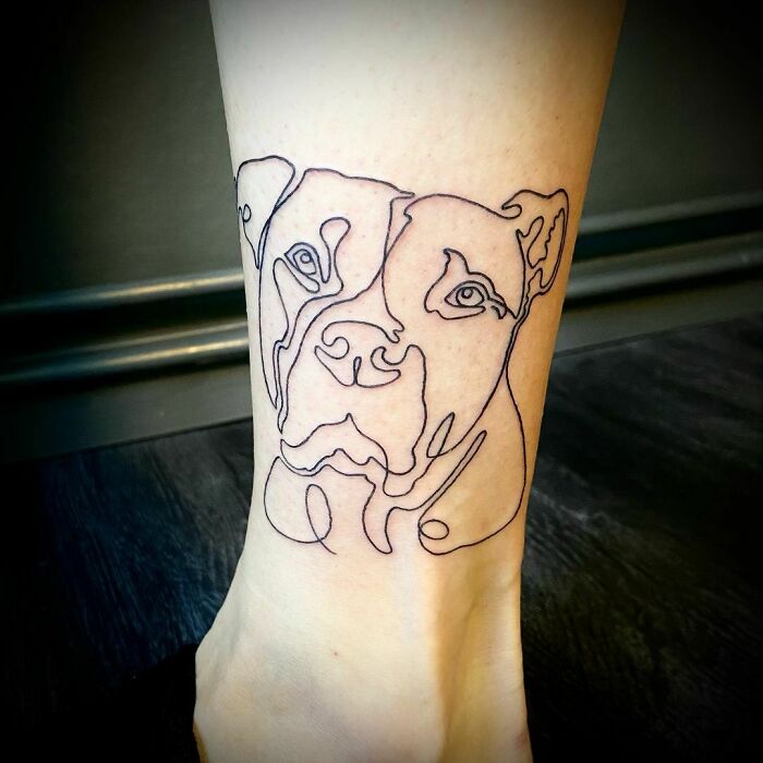 Single line dog head ankle tattoo