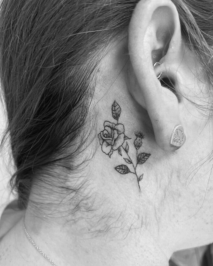 ear tattoo of a blooming rose with stem