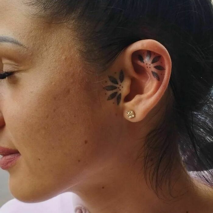 ear tattoo of dot leaves