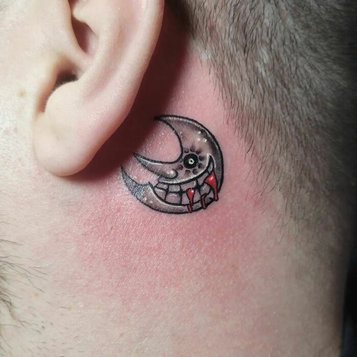 ear tattoo of a smiling soul eater