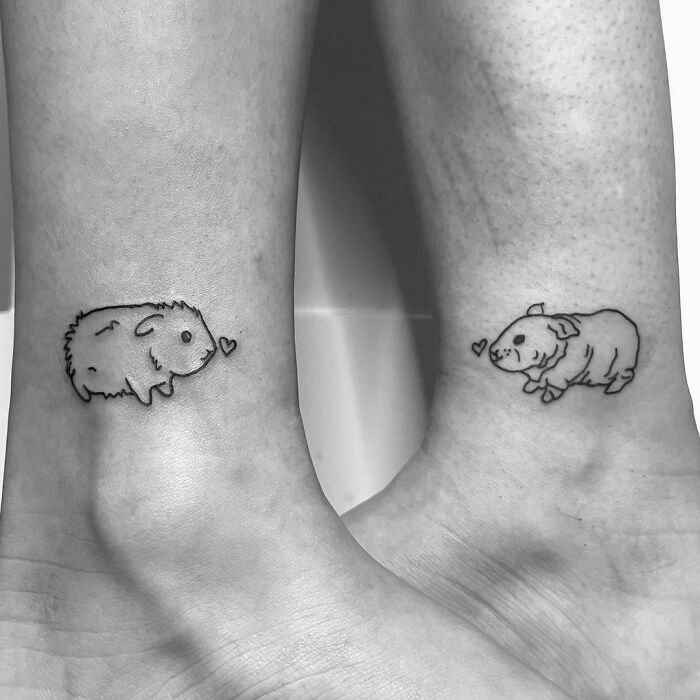 Matching best friend tattoos of guinea pigs with small hearts on ankles.