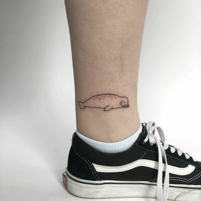 minimalistic tattoo of a sleeping seal