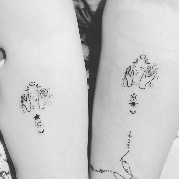 Hands with moon and stars matching tattoos