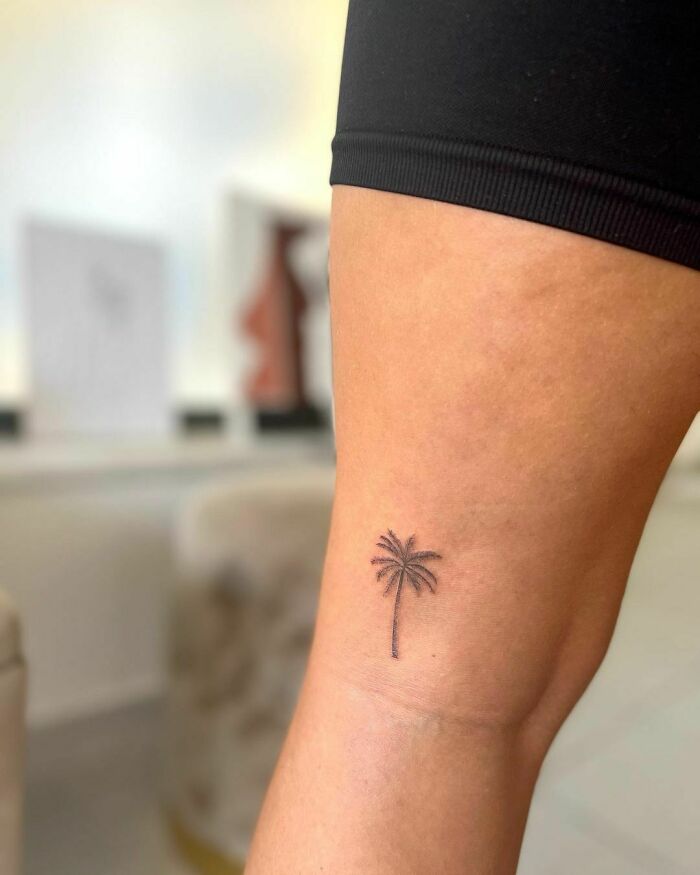 minimalistic tattoo of a palm tree