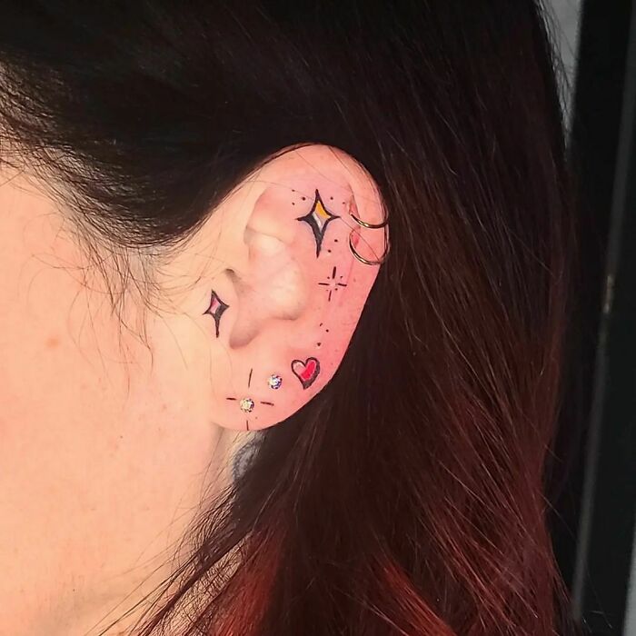 ear tattoo of a shimmering star and heart