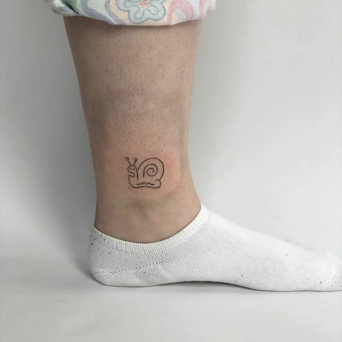 minimalistic tattoo of a snail