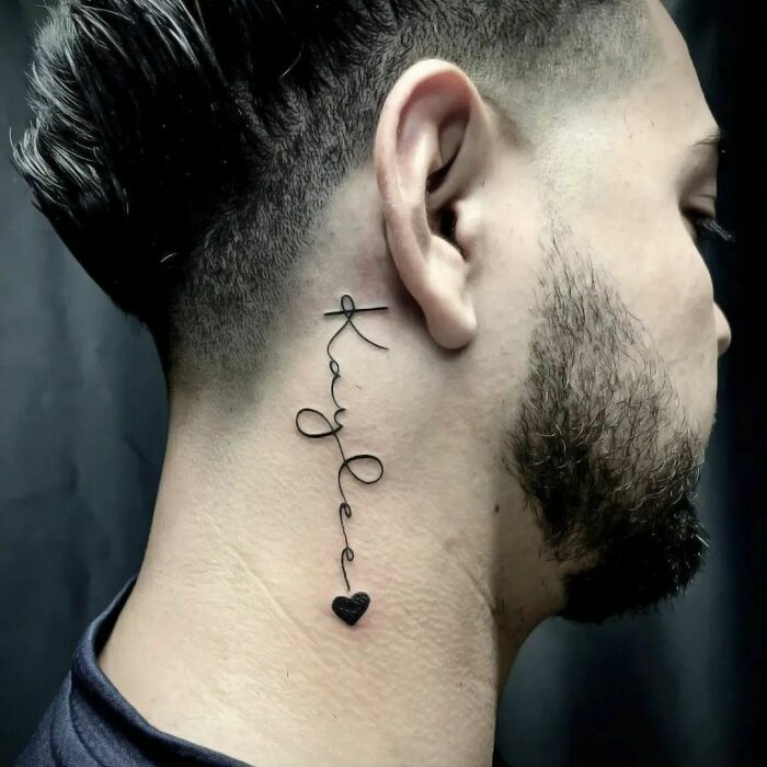 ear tattoo of typography name