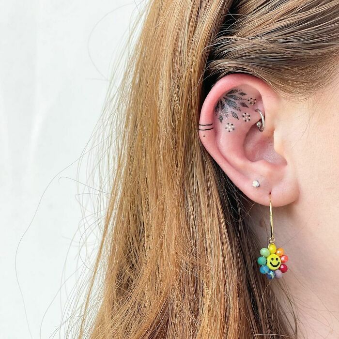 ear tattoo of a flower pattern 