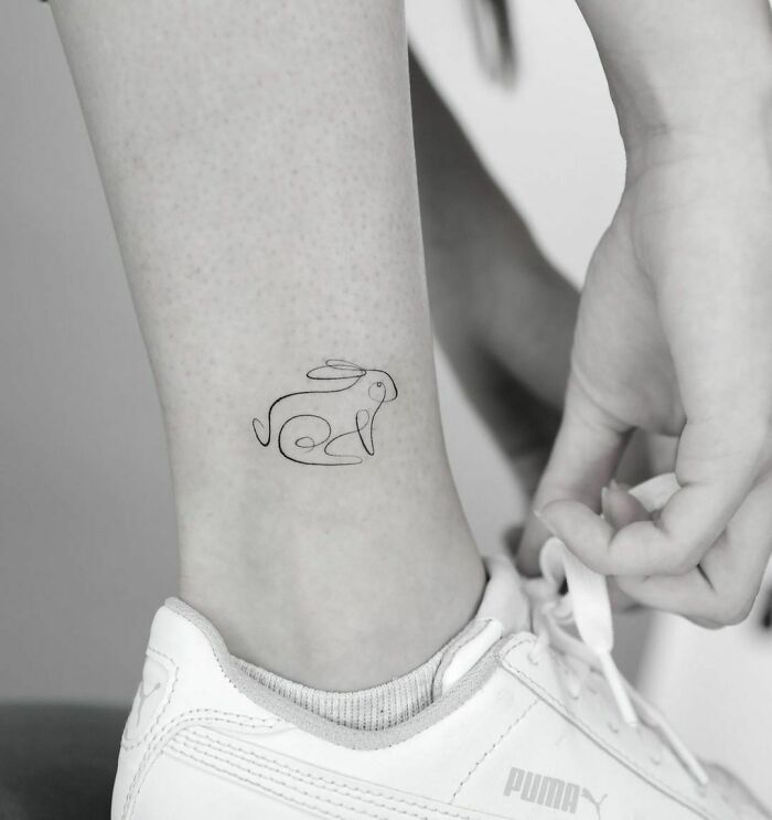 Minimalistic single line rabbit ankle tattoo