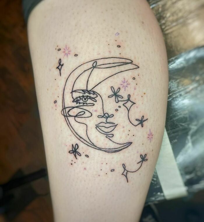 Single line moon with face tattoo