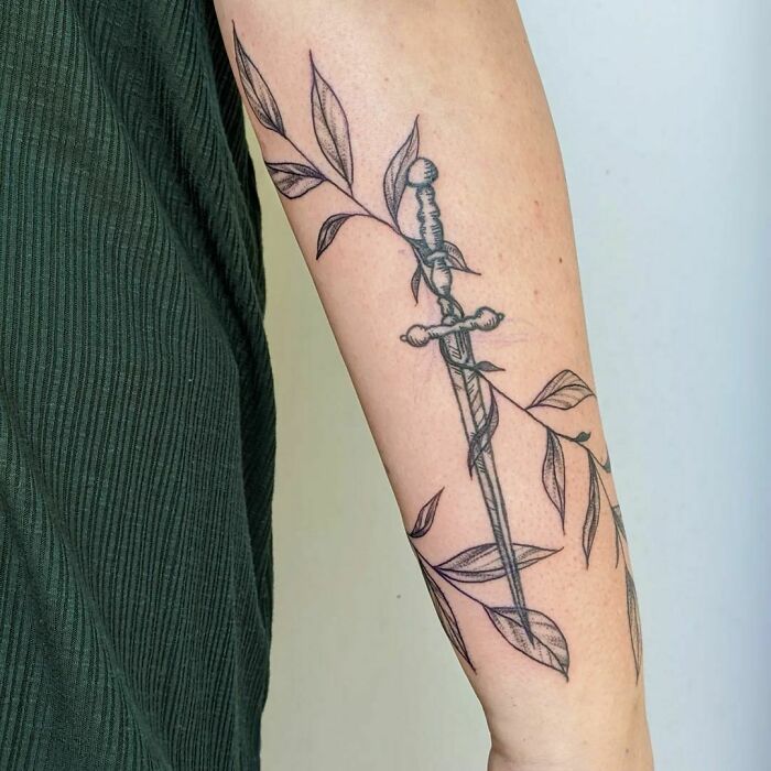 Pretty Leaves Around A Healed Sword Tattoo