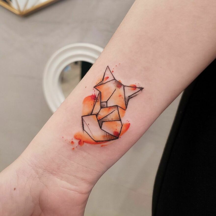 abstract red fox tattoo on the arm