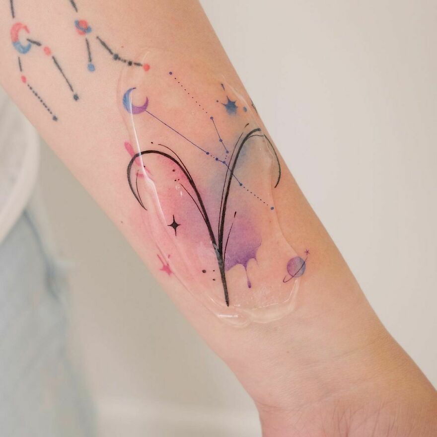 watercolor zodiac sign tattoo on the arm