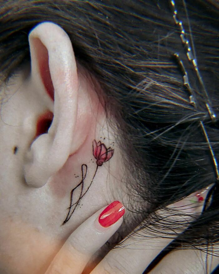 ear tattoo of a red flower