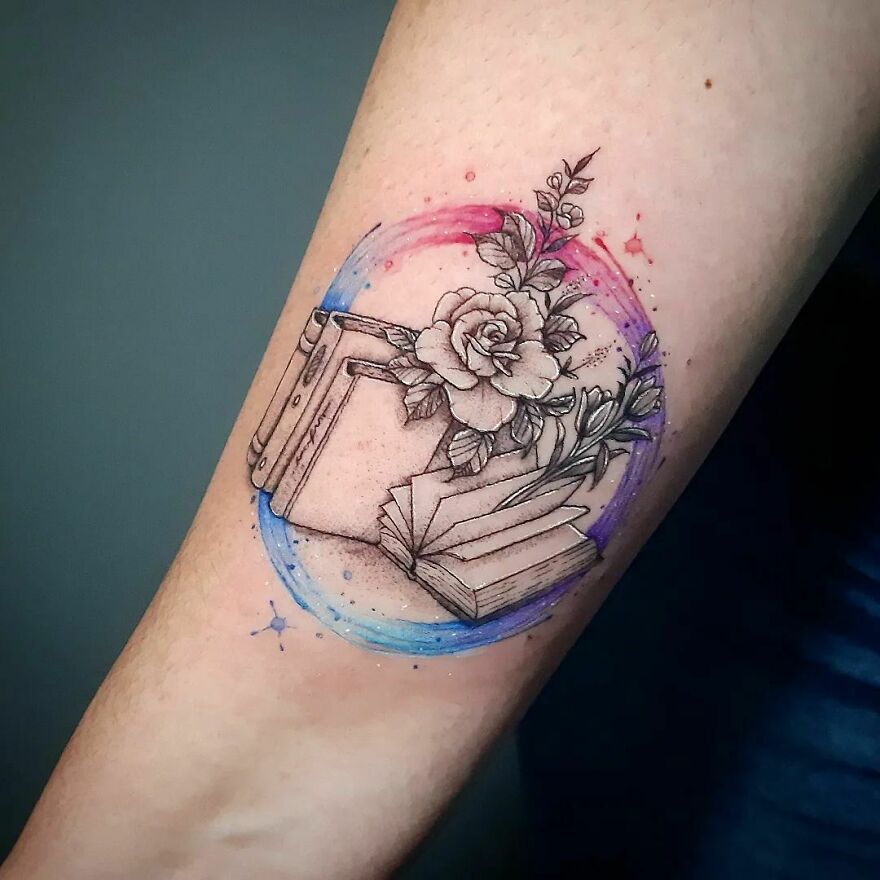 colorful books and flowers tattoo on the arm