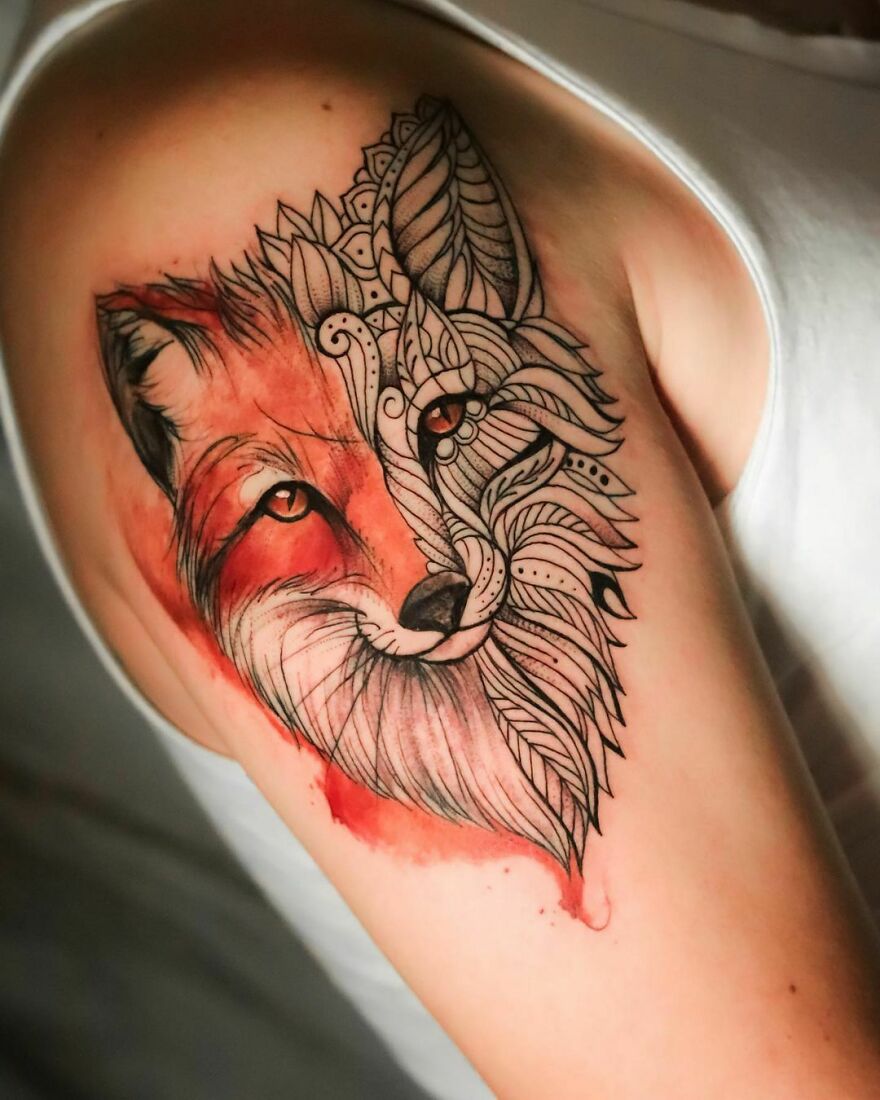 Watercolor fox tattoo on the left shoulder blade