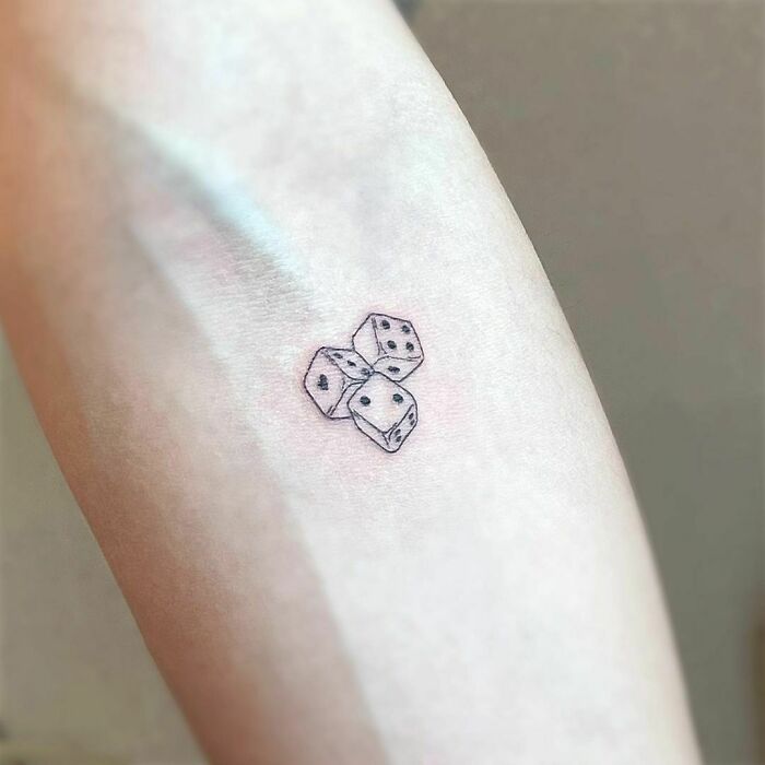 minimalistic tattoo of three dice