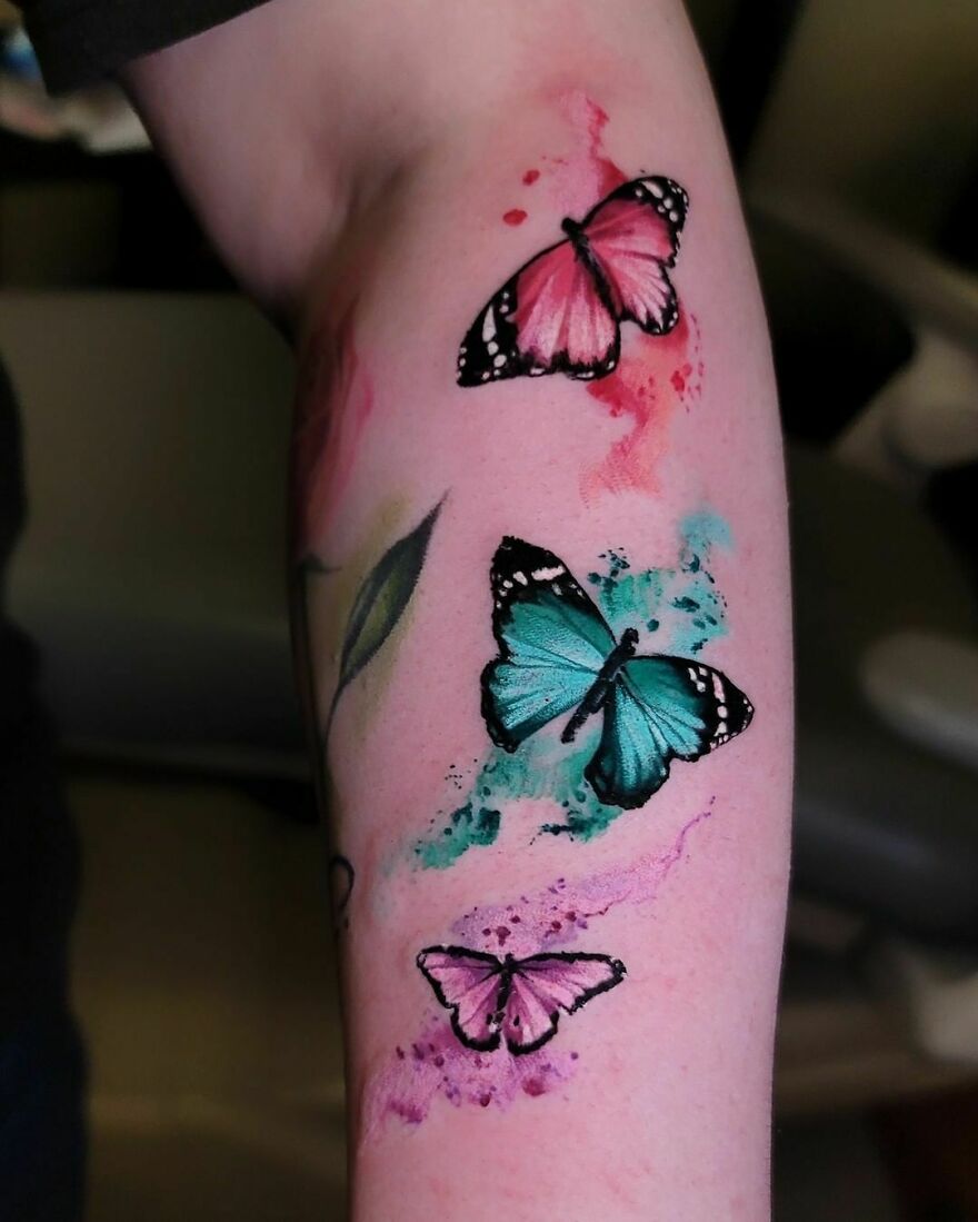 three colorful butterflies tattoos on the arm