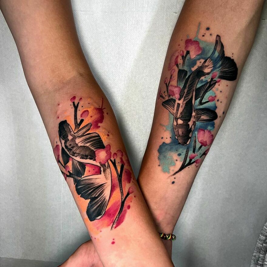 colorful matching koi fish tattoos on hands
