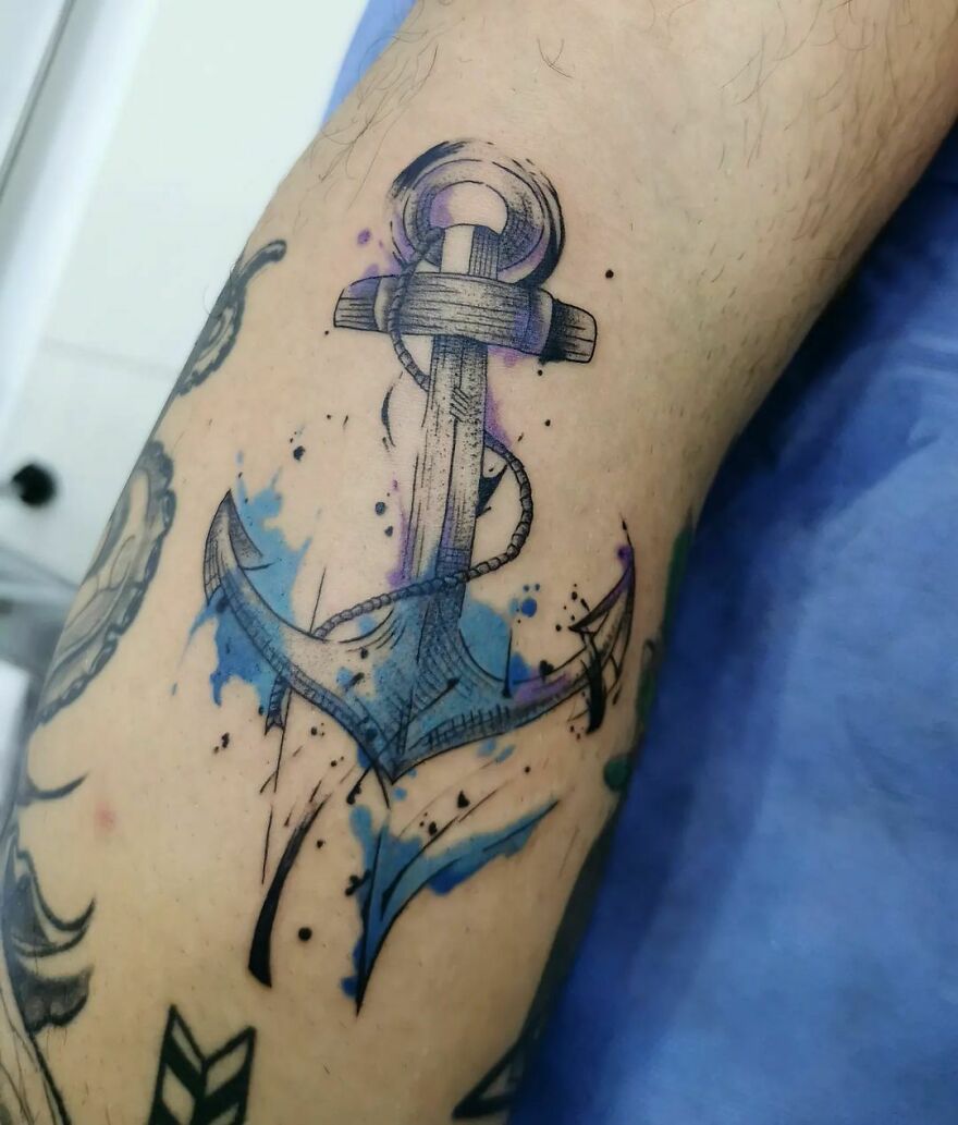 watercolor anchor tattoo on the arm