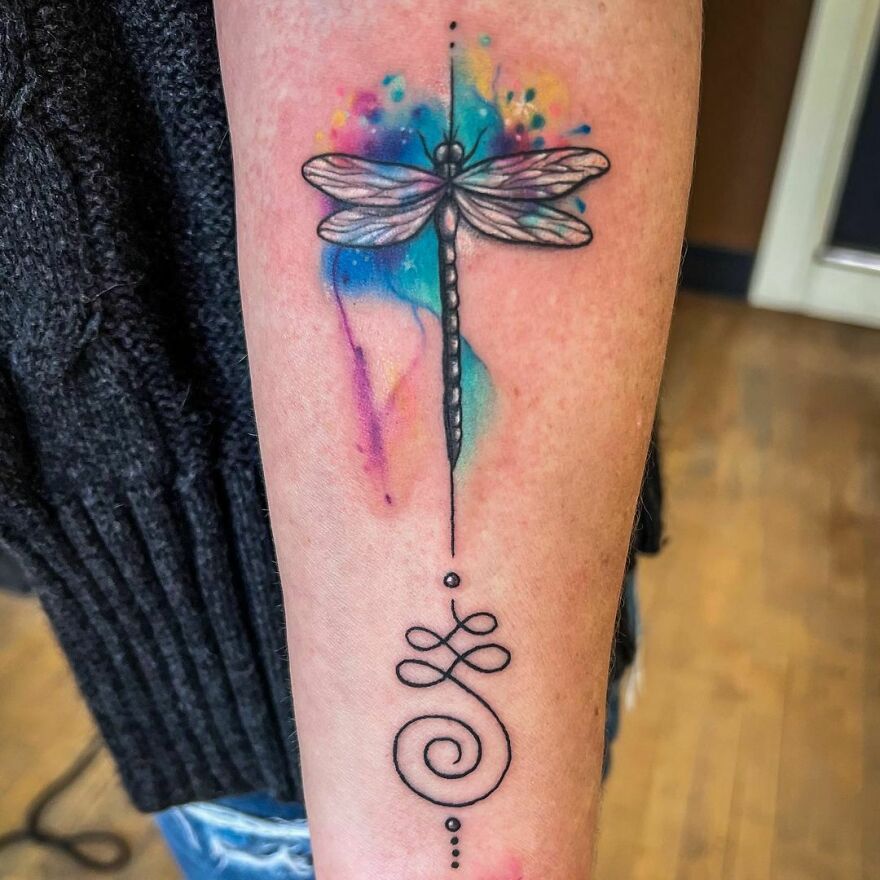 watercolor dragonfly tattoo on the arm
