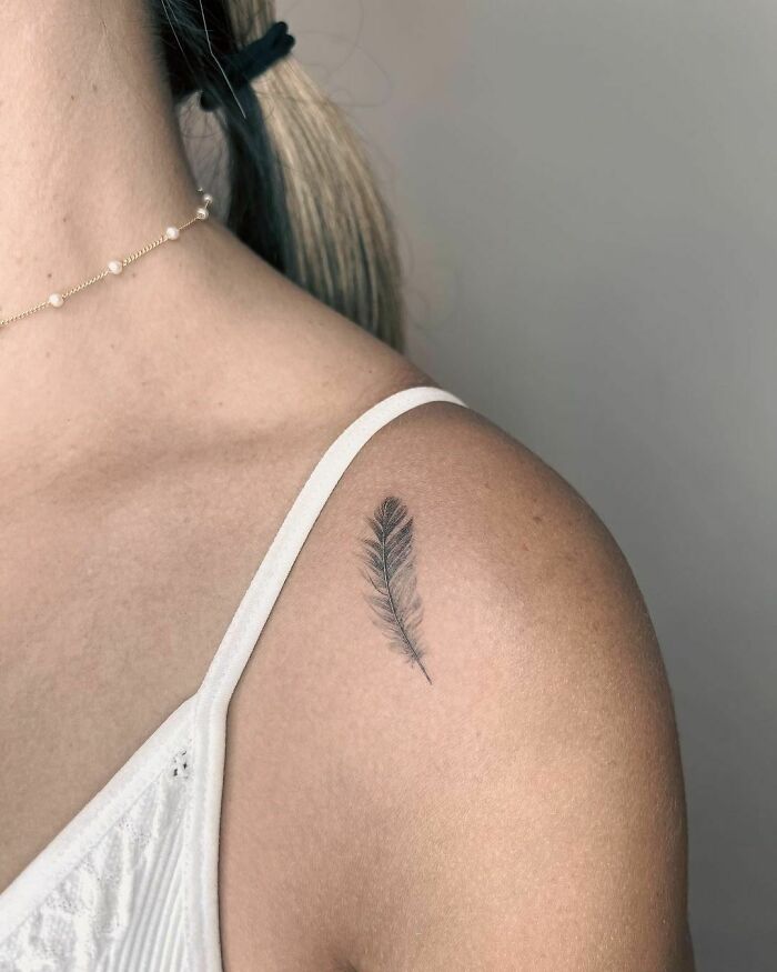 minimalistic tattoo of feather