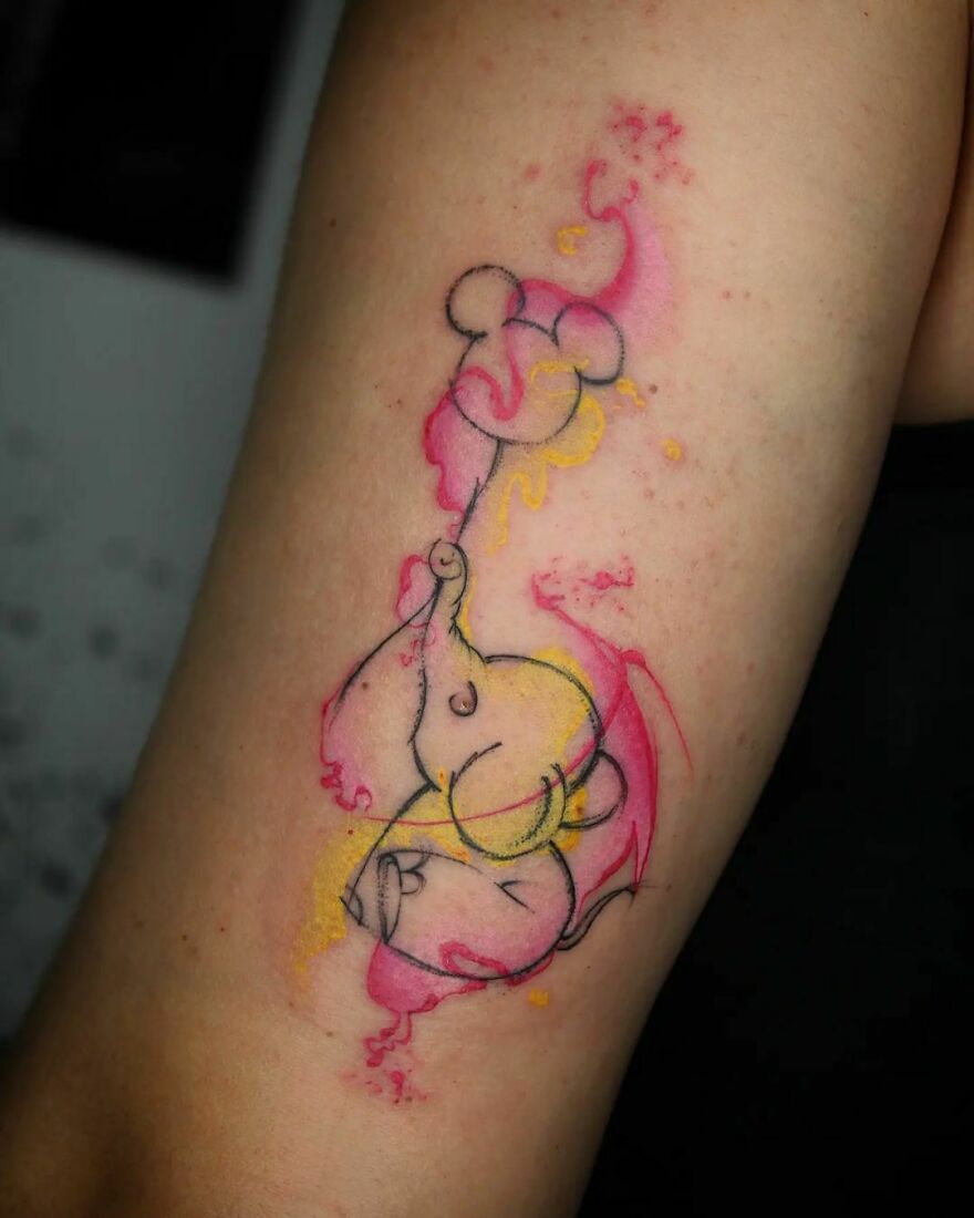 colorful elephant with water balloon tattoo on the arm