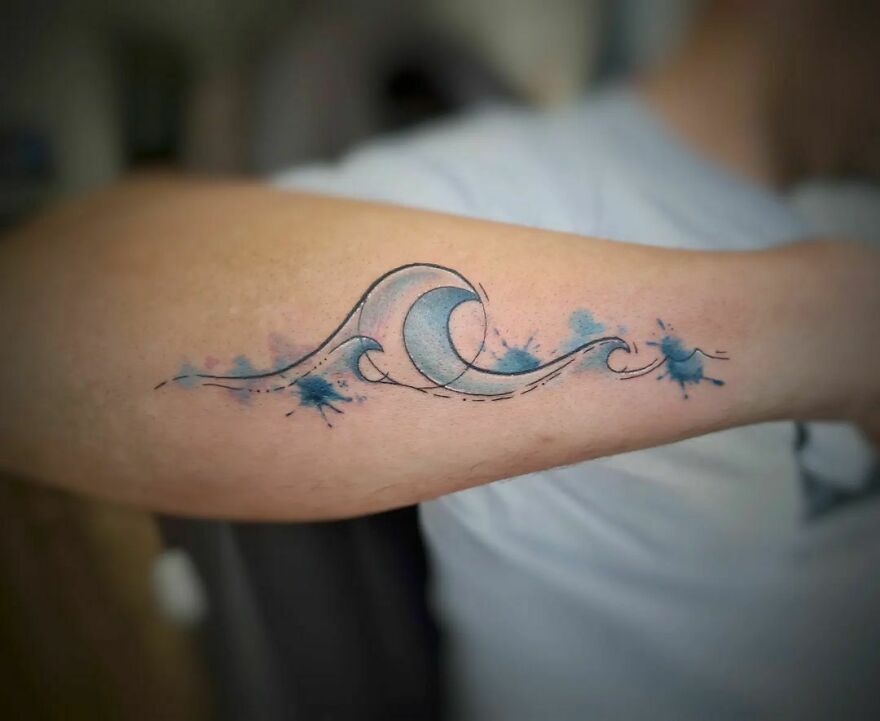 blue waves tattoo on the arm
