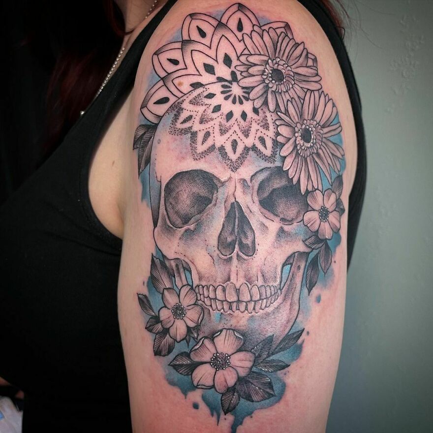 skull with flowers watercolor tattoo on the arm