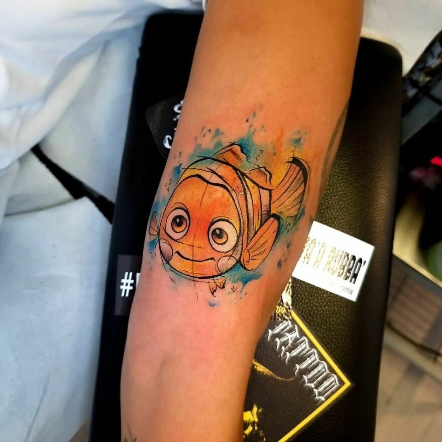 colorful nemo tattoo on the arm