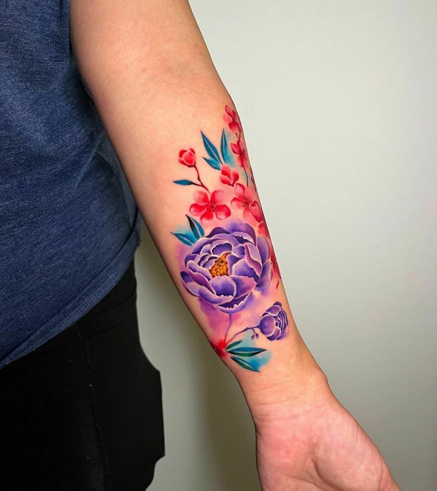 colorful flowers tattoo on the forearms