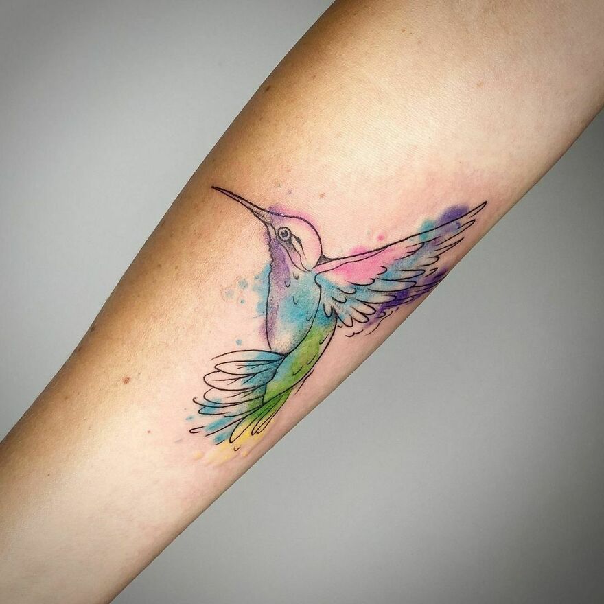 colorful hummingbird tattoo on the forearm