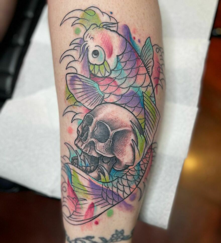 colorful fish and skull tattoo on the arm