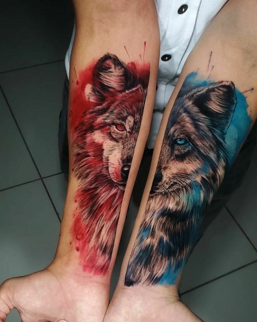 colorful half of wolf face tattoos on the arms