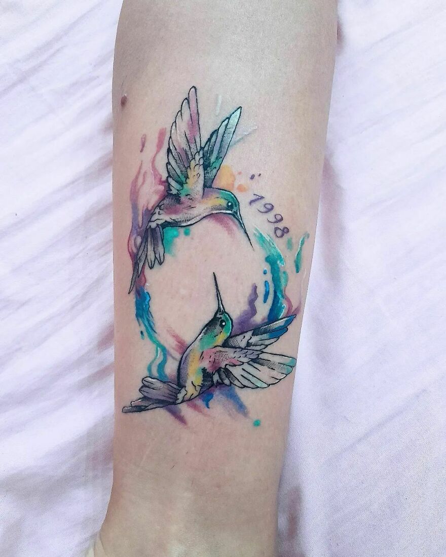 colorful hummingbirds tattoo with a date on the leg