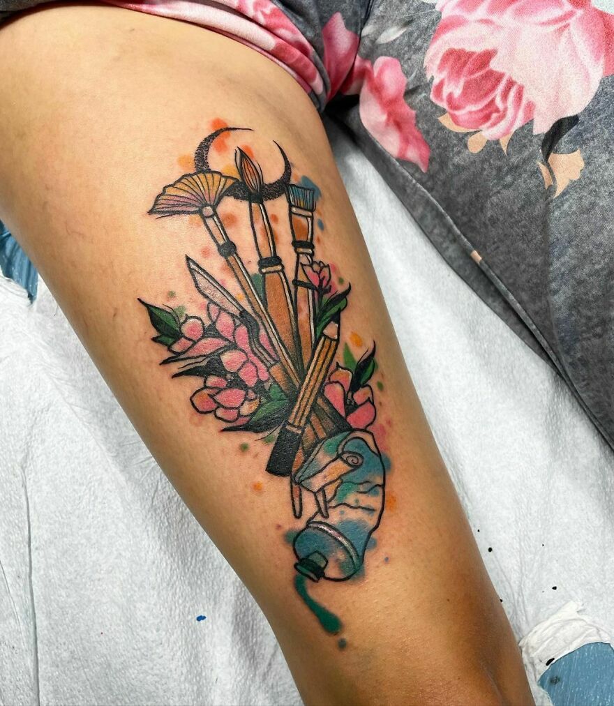 dye with brushes and flowers tattoo on the arm