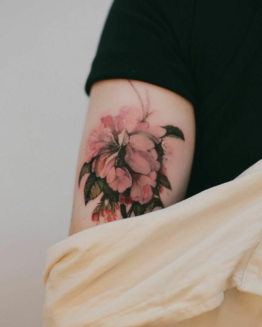 watercolor flowers tattoo on the arm