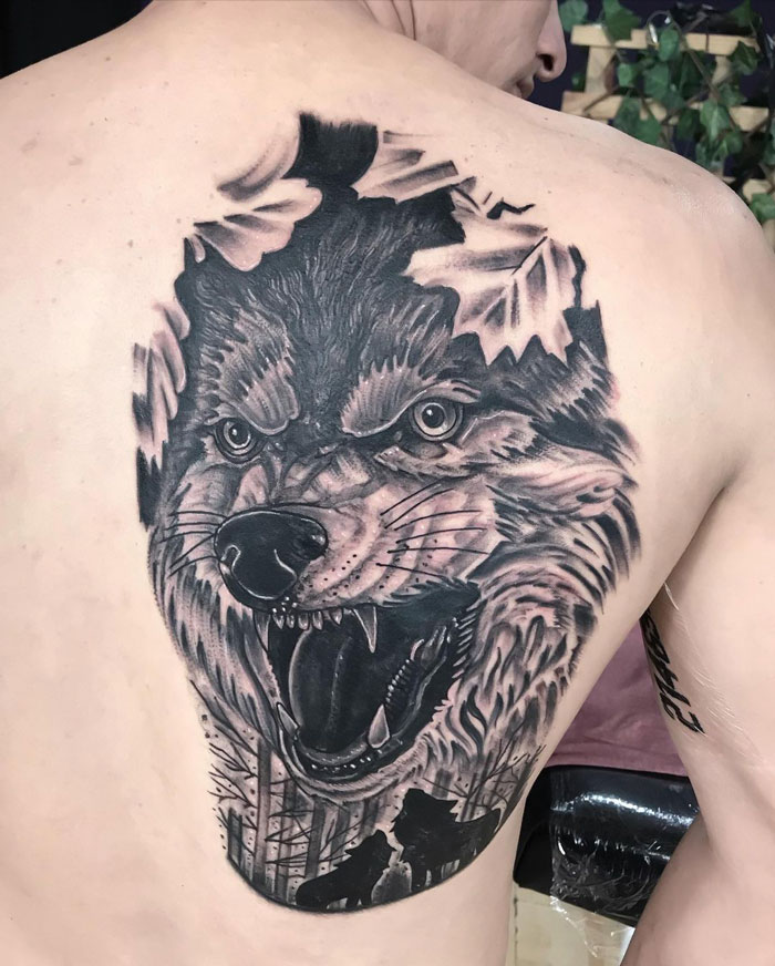 Wolf face tattoo on back