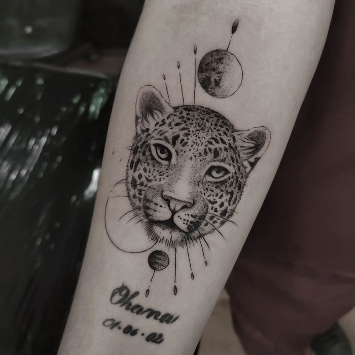 Leopard face tattoo on arm