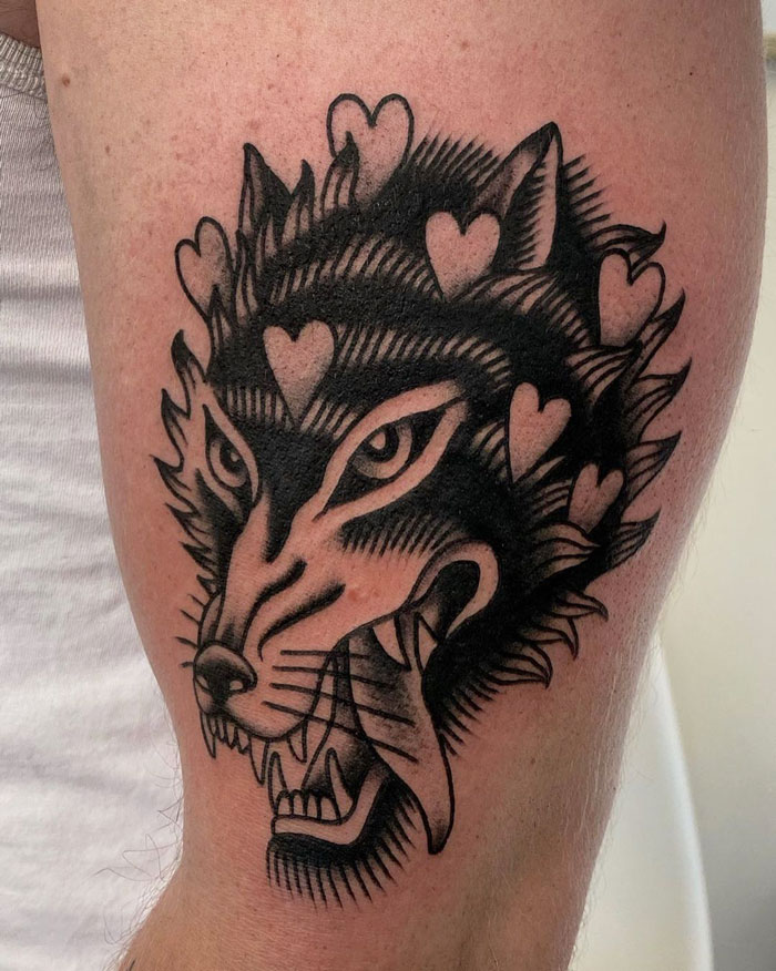Wolf head with hearts in its fur tattoo