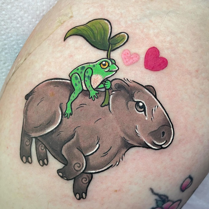 Colorful capybara and frog on its back tattoo