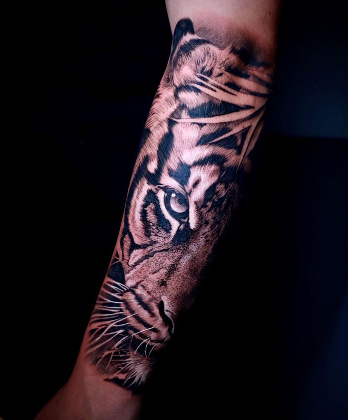 Tiger face tattoo on arm