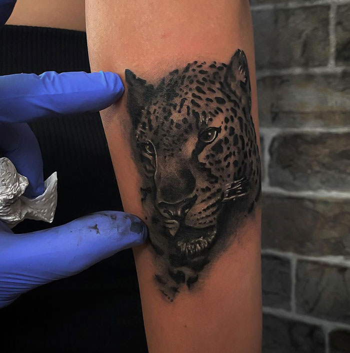 Realistic leopard portrait tattoo