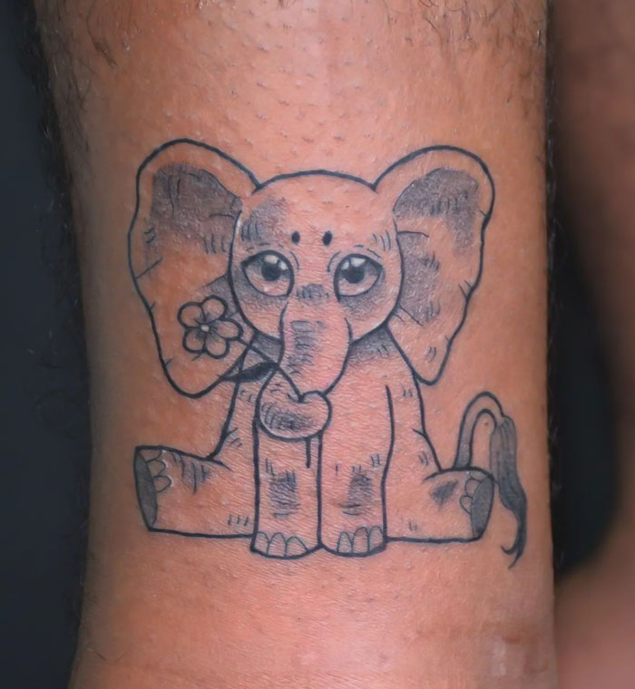 Baby elephant with flower tattoo