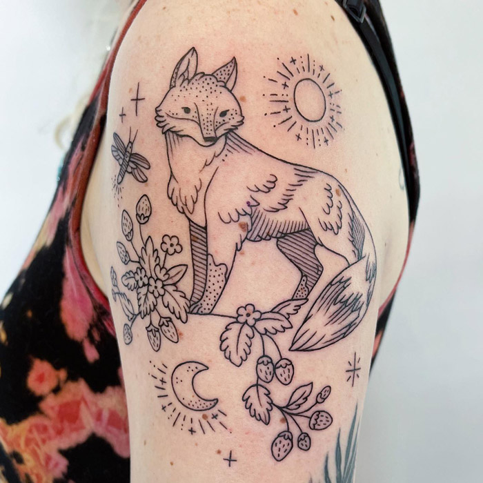 Fox tattoo with floral and celestial elements on arm, showcasing unique animal tattoo design.