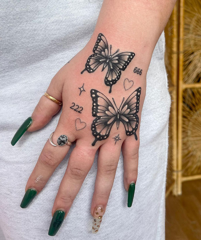 Two butterflies on hand tattoo