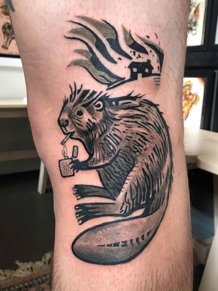 Beaver lightning up a cigarette and a house on fire tattoo on leg