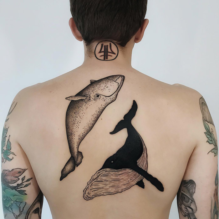 Two large whales tattoo on back