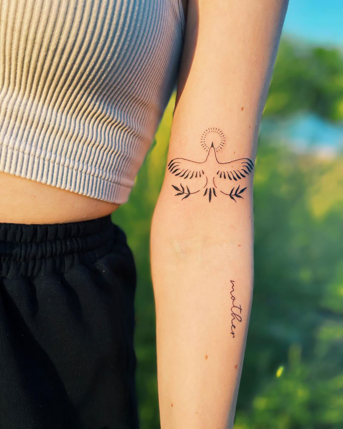 Minimalist bird tattoo on forearm, showcasing animal tattoo simplicity and realism.