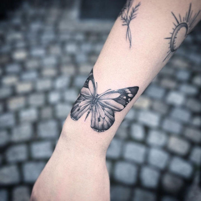 Realistic butterflie tattoo on arm